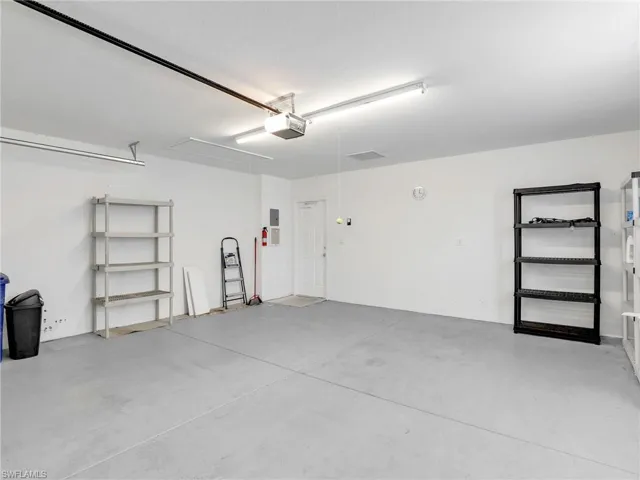 Garage featuring a garage door opener