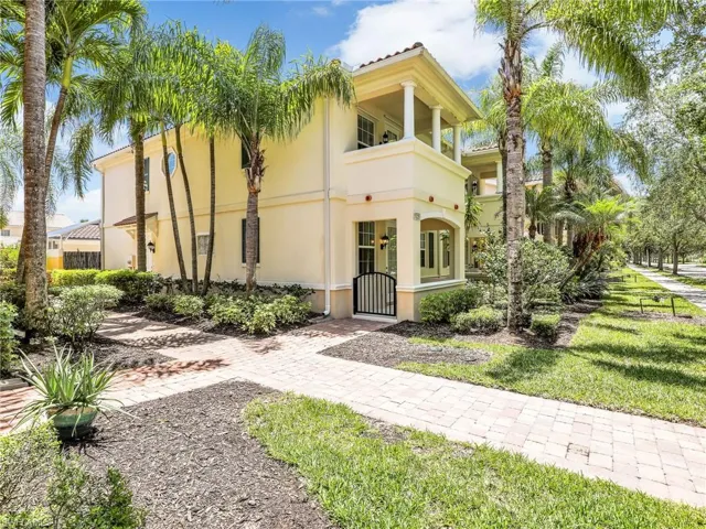 Mediterranean / spanish-style home featuring stucco siding, a gate, and a balcony