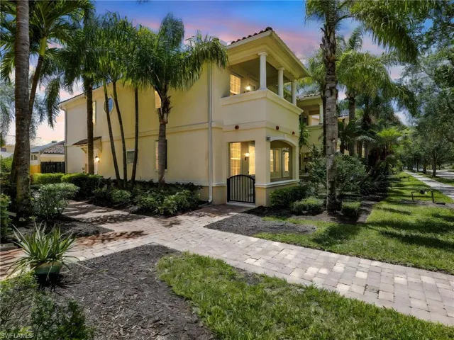 Mediterranean / spanish-style home featuring stucco siding, a gate, and a balcony