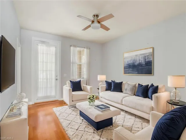 Living room with ceiling fan and wood finished floors