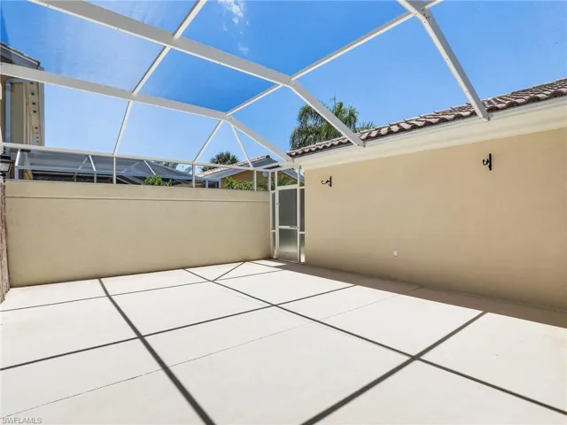 View of patio featuring a lanai