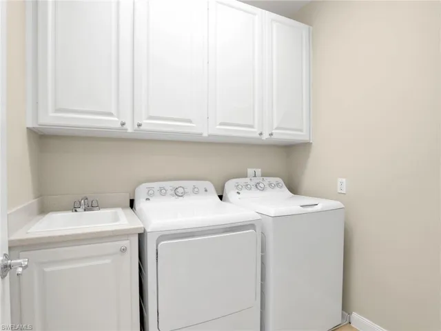 Laundry area with cabinet space and washer and dryer