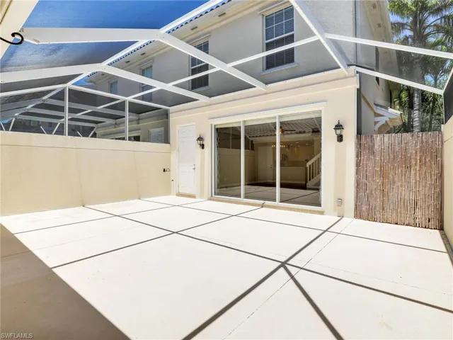 Rear view of property featuring stucco siding, a patio, and fence