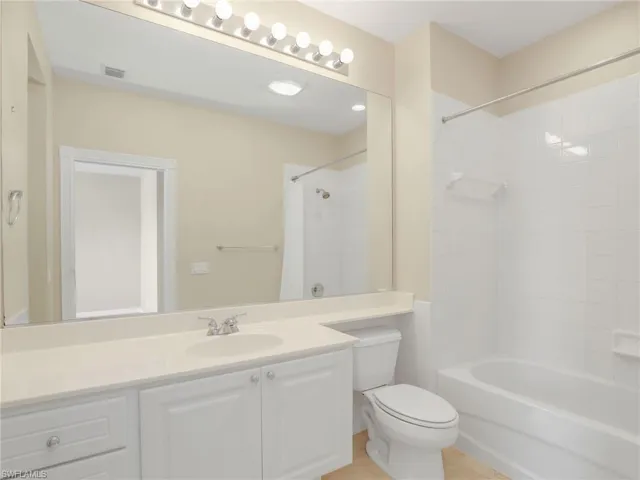 Full bath featuring toilet, vanity, and shower / bath combination