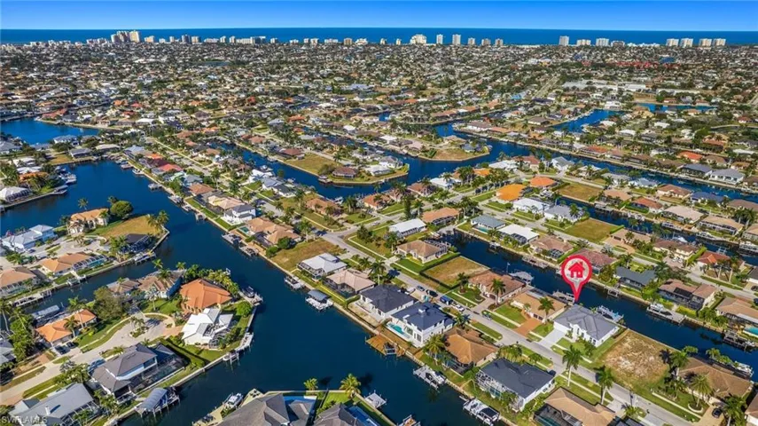 Aerial view of property's location with a large body of water and nearby suburban area