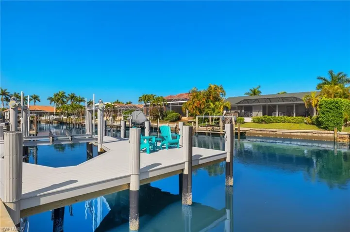 Dock featuring boat lift and a water view