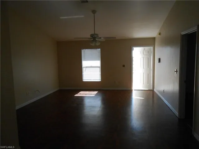 Spare room featuring baseboards and ceiling fan