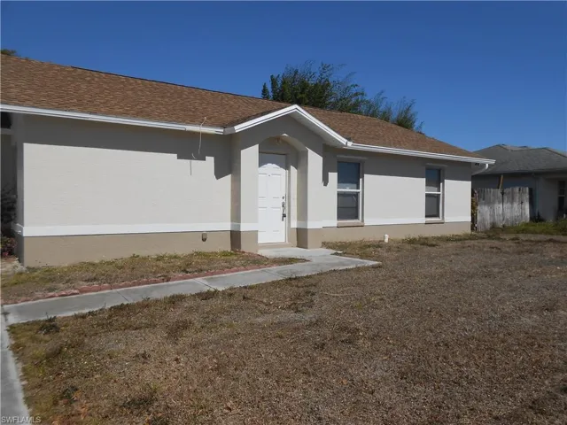 Single story home with stucco siding and a shingled roof