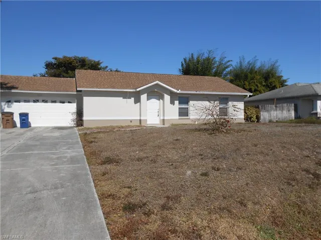 Ranch-style home with concrete driveway, a garage, and a shingled roof
