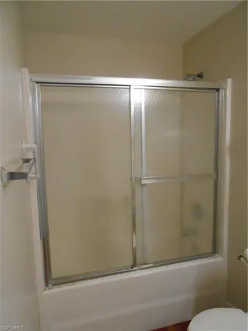 Bathroom with a shower with door