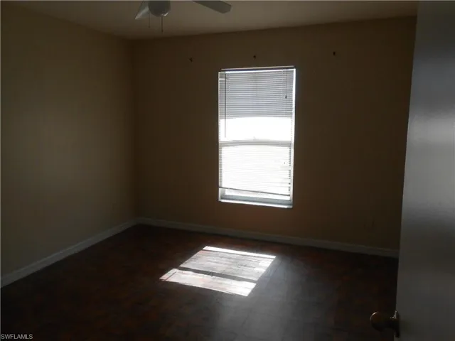 Empty room featuring baseboards and ceiling fan