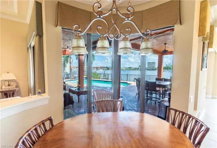 Dining room with an inviting chandelier and crown molding