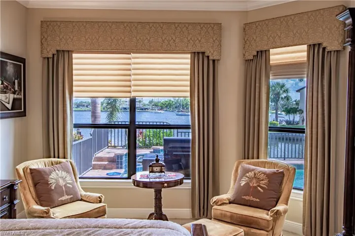 Master Bedroom with a tray ceiling, ornamental molding, light tile patterned floors, ceiling fan, and recessed lighting