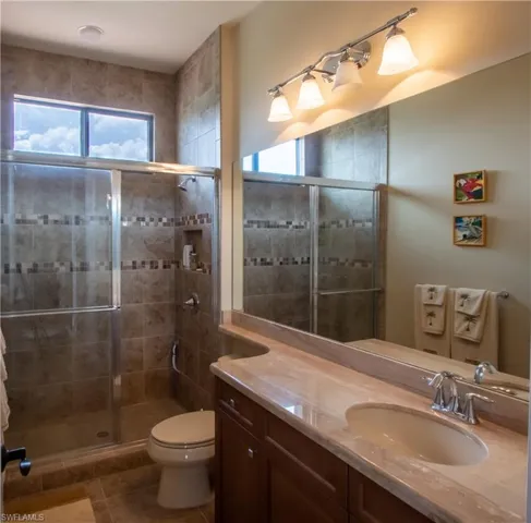 Bedroom with light carpet, access to outside, baseboards, visible vents, and ceiling fan