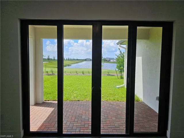 Doorway to outside featuring healthy amount of natural light and a water view