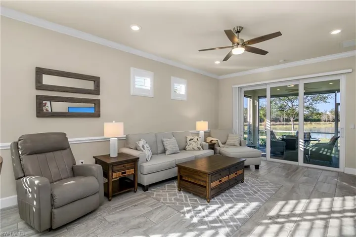 Living room with crown molding and lake view