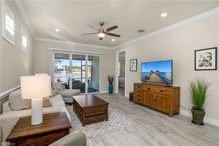 Living room featuring lake view and crown molding