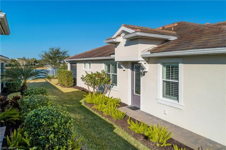 View of property exterior featuring a yard and stucco siding