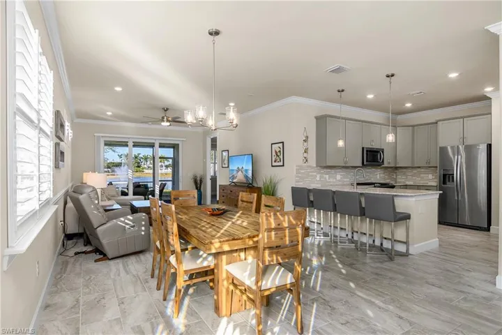 Open concept, crown molding, plank tile flooring, plantation shutters