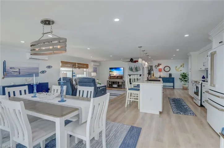 Dining area featuring light wood finished floors, recessed lighting, and ceiling fan