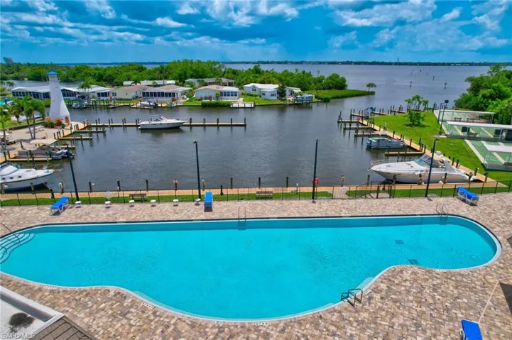 Community pool with a dock and a water view