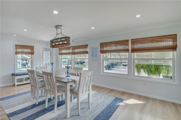 Dining space featuring light wood-style flooring, recessed lighting, and ornamental molding
