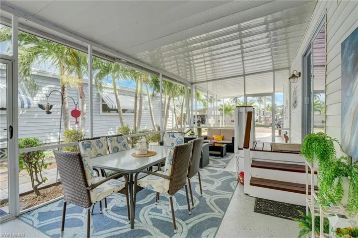 Sunroom with an outdoor living / dining area and healthy amount of natural light