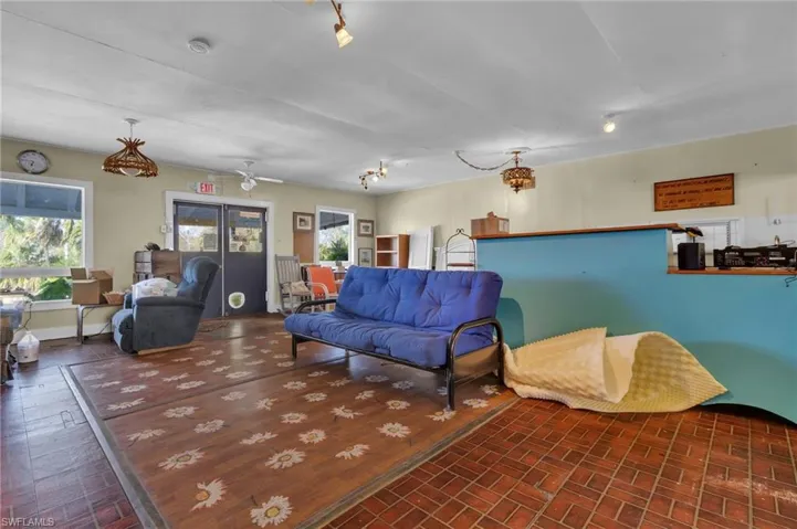 Living room featuring brick floor and baseboards