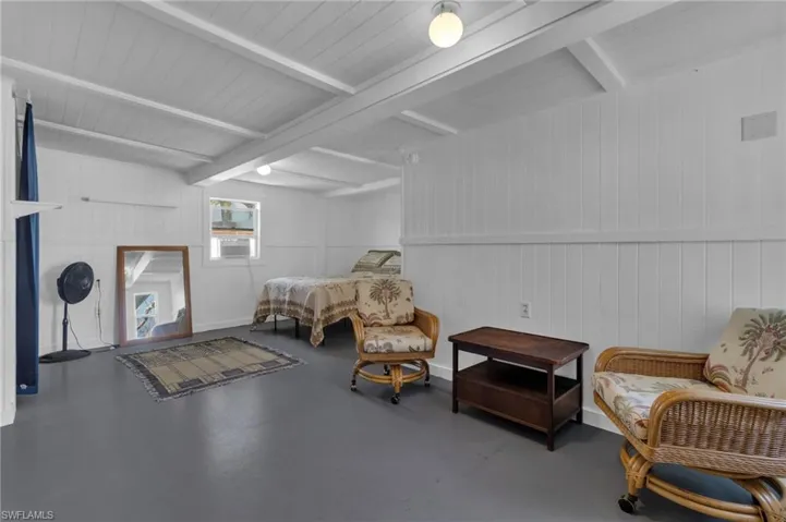 Living area with beamed ceiling and cooling unit