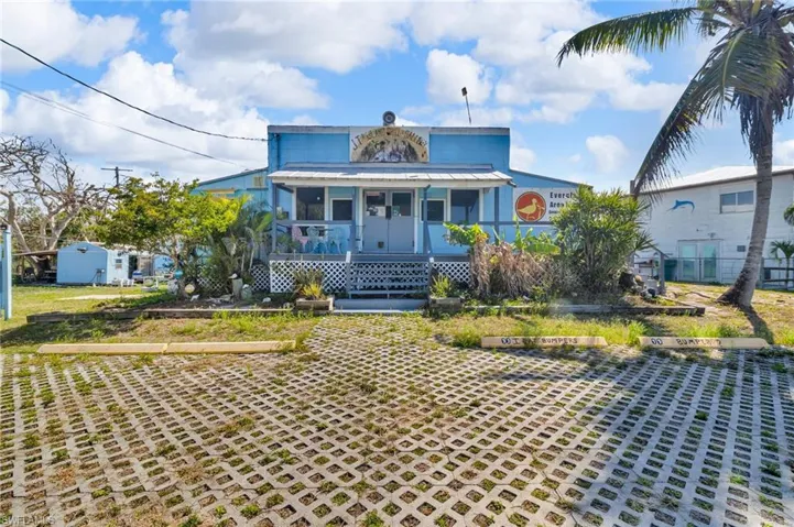 View of front of house with covered porch and metal roof
