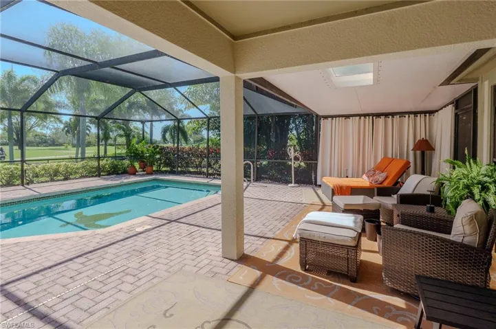 Outdoor pool with a patio, a sunroom, a lanai, and an outdoor lounge area