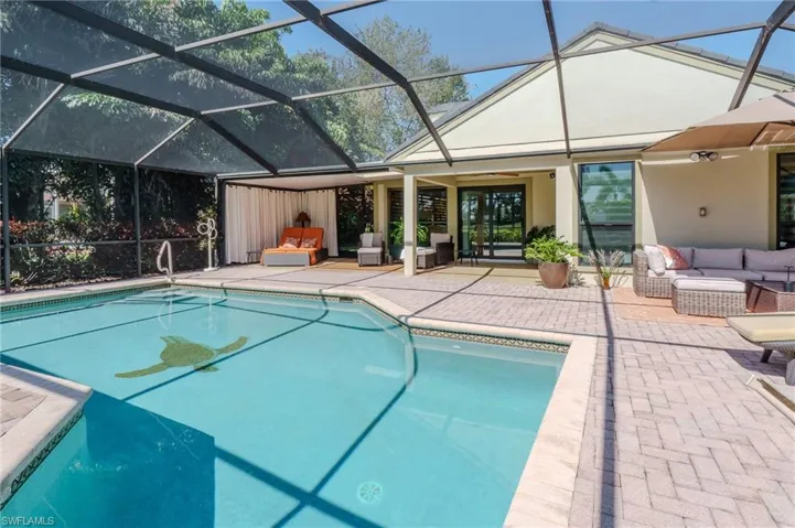 Swimming pool with an outdoor hangout area, a patio, a sunroom, and a lanai