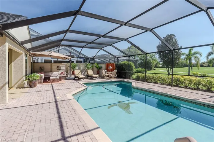 Outdoor pool featuring a sunroom, a patio area, and a lanai