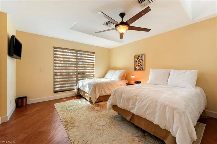 Bedroom featuring hardwood / wood-style flooring and a ceiling fan