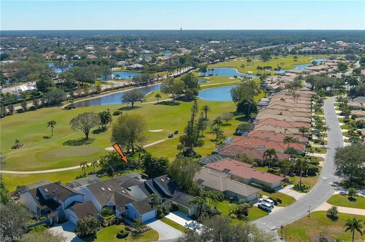 Aerial view of property and surrounding area with a large body of water and nearby suburban area