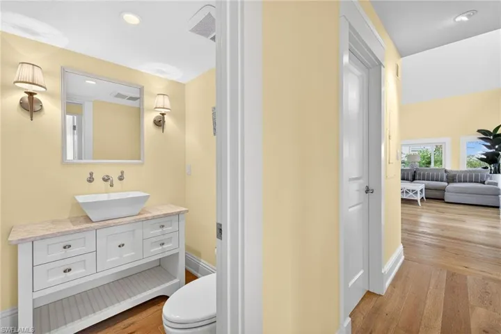 Bathroom featuring light wood-style floors, vanity, and recessed lighting