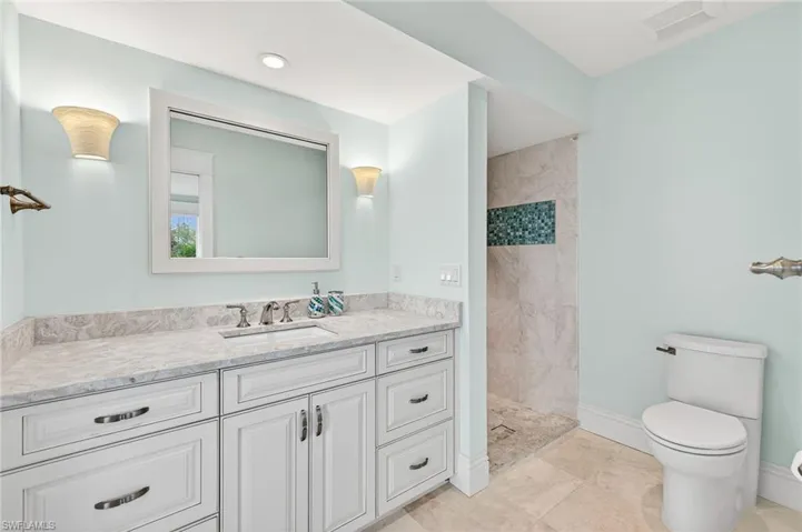 Full bath featuring vanity and a tile shower