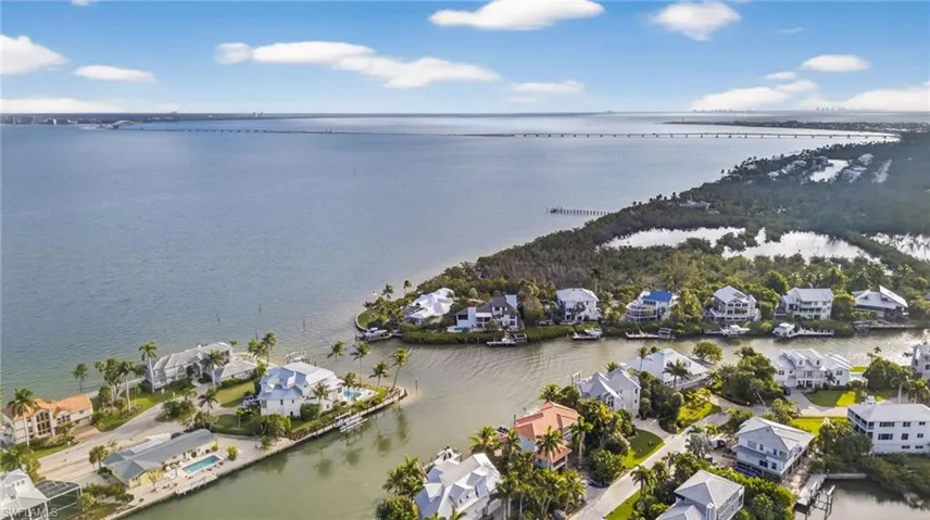 Aerial view of property's location featuring nearby suburban area and a nearby body of water