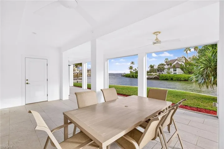 Sunroom / solarium featuring a water view and tile patterned flooring