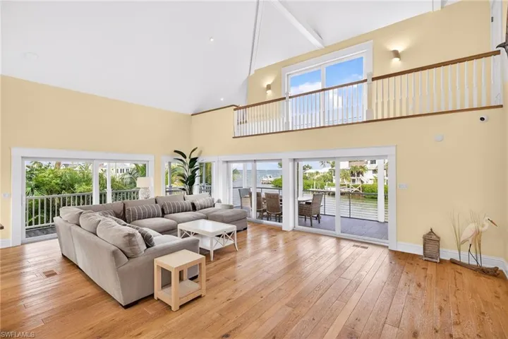 Living area featuring light wood-type flooring and high vaulted ceiling