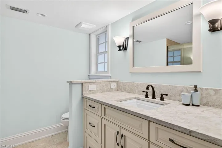Bathroom featuring vanity, a shower, and light tile patterned flooring