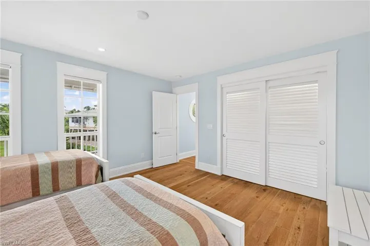 Bedroom with light wood-style flooring, a closet, and recessed lighting