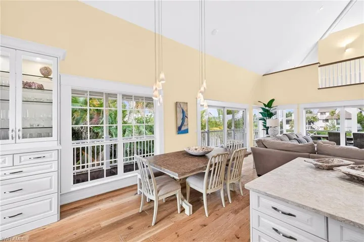 Dining room featuring high vaulted ceiling and light wood-style flooring