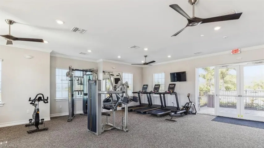 Exercise room featuring ornamental molding, carpet flooring, ceiling fan, and french doors