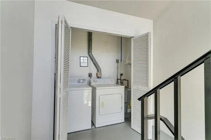 Dedicated laundry closet featuring louvered bi-fold doors, a washer, and a dryer