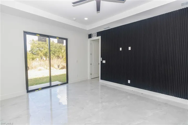 Living room with light marble finish floors and ceiling fan