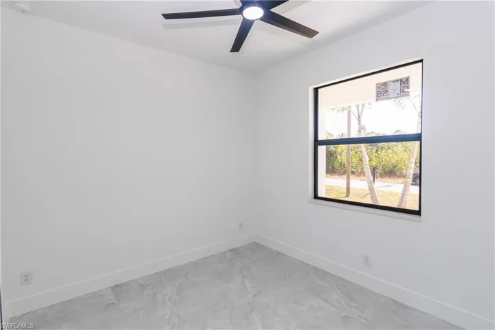 Bedroom featuring baseboards and ceiling fan