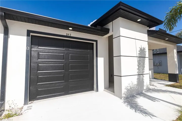 Entrance to property featuring stucco siding