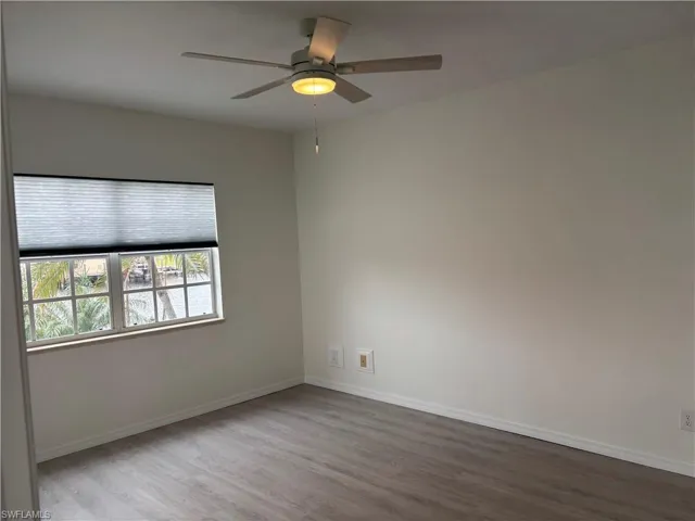 Master bedroom has new LVP flooring, ceiling fan and window treatments.