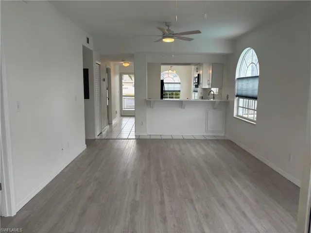 View of living area toward kitchen and guest bath and bedroom, left side of hall